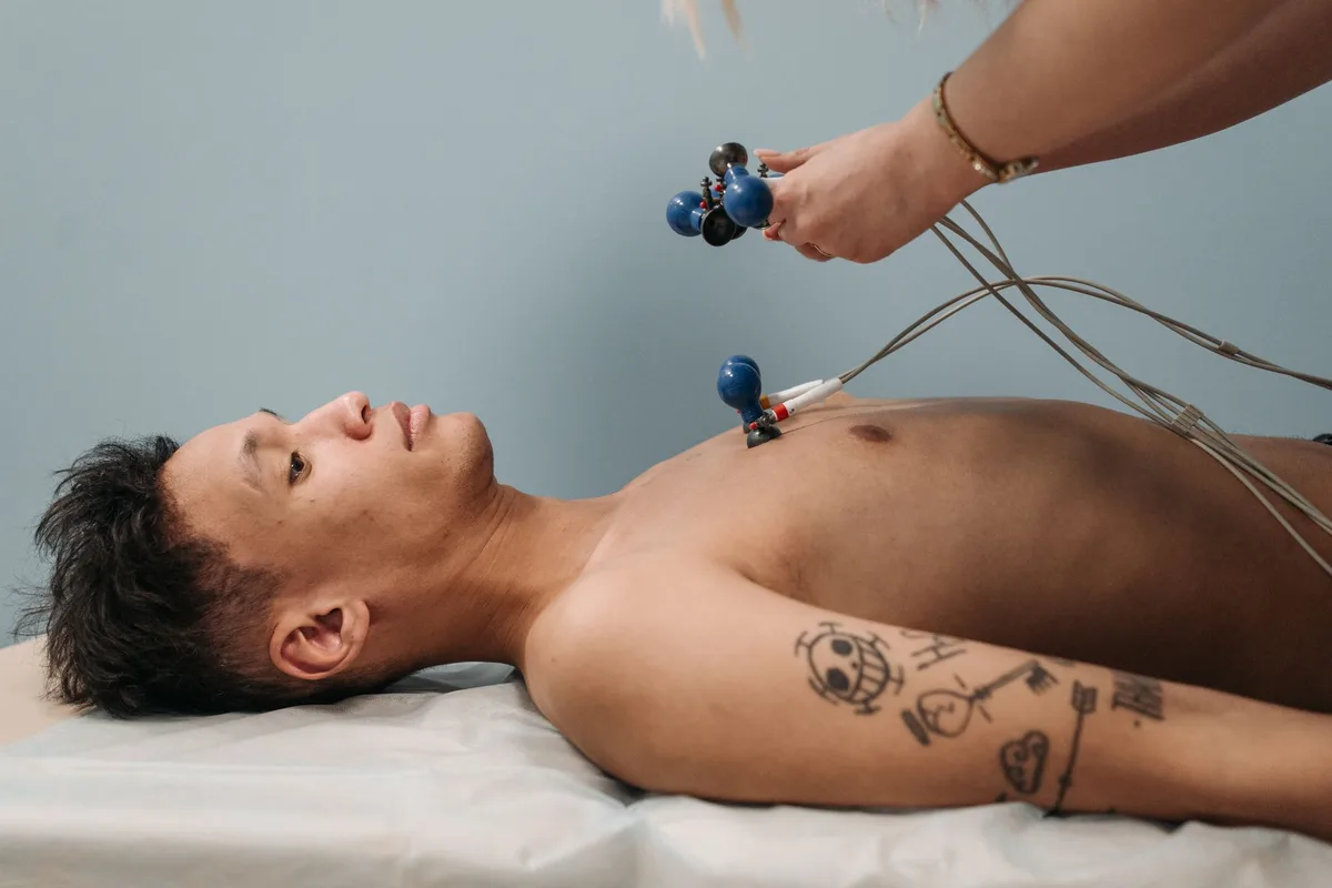 Electrodiagnostic electrodes and a recording monitor in a darkened clinical room.