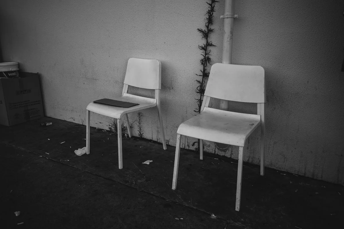 An empty clinical examination room in hard shadow.