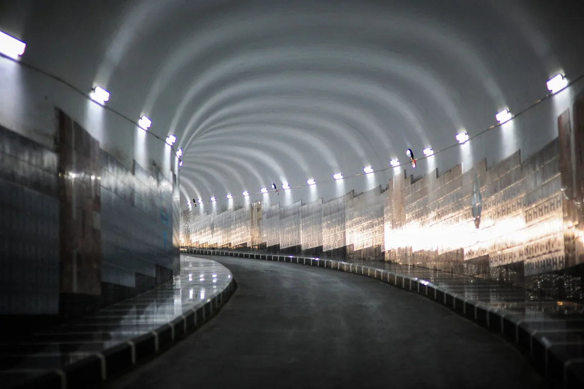 A long empty corridor receding into darkness.