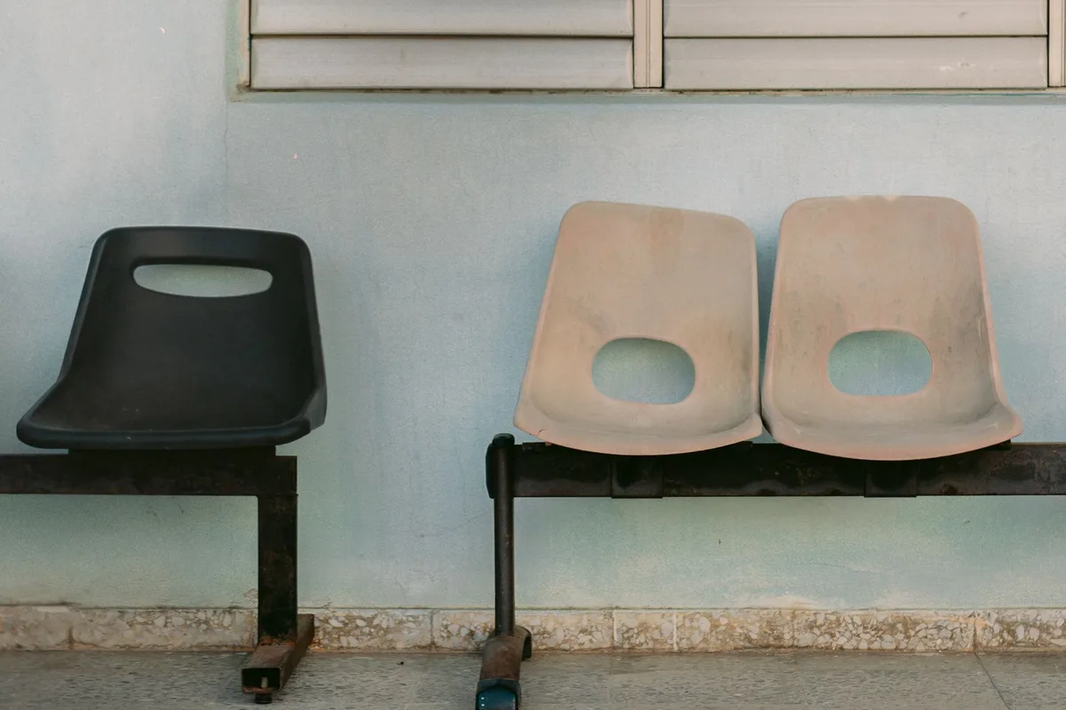 Empty clinic chairs in low light with hard shadows.